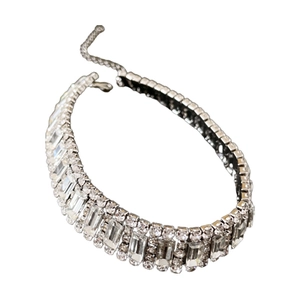 Sparkling silver wide choker necklace with geometric rows of clear crystals on white background