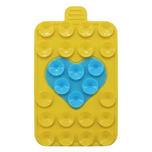 Detail of a rectangular silicone phone suction cup mount with blue heart and yellow base