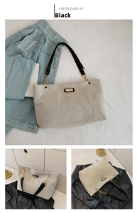 Detail of nylon tote bag with golden deer charm and black leather shoulder straps