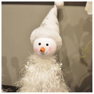 Close-up of plush snowman doll with silver snowflake hat and faux fur textures