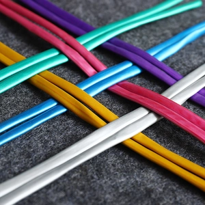 Vibrant metallic twisting balloons set for creative shapes on grey felt background