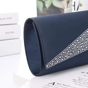 Elegant navy blue satin evening clutch with sparkling diamond accents in side profile view