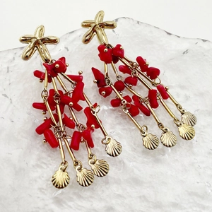 Bohemian gold starfish and coral red fringe earrings with shell pendants on white backdrop