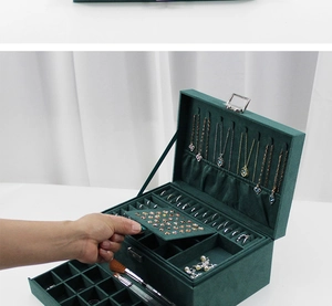 Detail view of green velvet jewelry box with three layers and multiple storage compartments