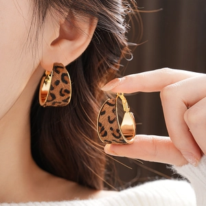 Detailed close-up of brown leopard print C-shape earrings with gold plating finish