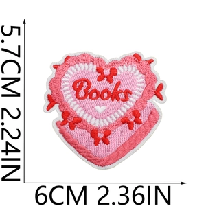 Macro shot of heart-shaped Books embroidery patch showing size measurement 6cm x 5.7cm