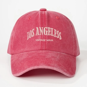 Detail of vintage red washed cotton baseball cap with Los Angeles embroidery