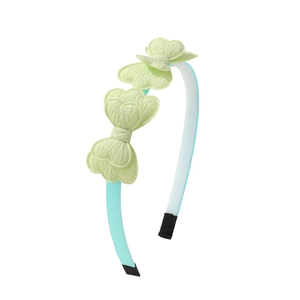 Detail of mint green headband with three yellow fabric bows showing texture and stitches