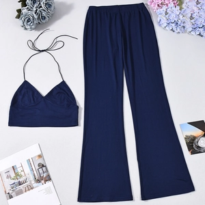 Detail of navy blue two-piece set featuring halter crop top and high-waist wide-leg pants