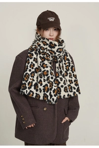 Detailed texture of leopard print scarf worn with a brown coat for winter styling