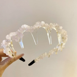 Detail of light pink acrylic crushed stones on transparent headband with sawtooth grip