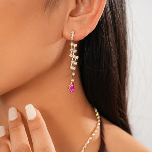 Detail of luxury drop fringe earring with pink teardrop crystal and sparkling zircon