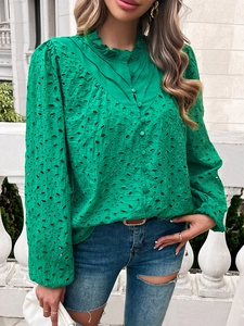 Close-up of green hollow lace blouse with elegant lantern sleeves and puff shoulders