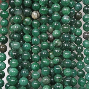 Close-up of natural green mica round beads showing unique stone texture and polished finish