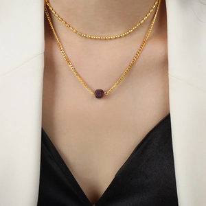 Double-layered gold-plated necklace with purple square agate pendant on a fashion model