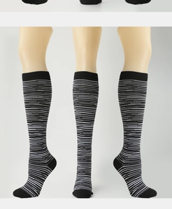 Detail view of black and white striped compression socks showing fit from multiple angles