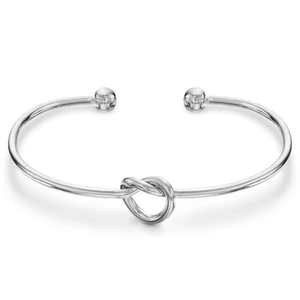 Detailed view of silver knot cuff bangle bracelet with minimalist polished metal finish