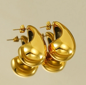 Detailed view of large gold-plated teardrop earrings with a high-polished mirror finish