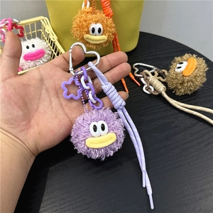 Plush purple cartoon monster keychain with star pendant and woven rope for bags