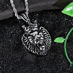 Macro view of carved lion head pendant with crown and round bead on twisted chain