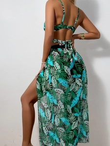 Detail of tropical leaf print bikini with high-slit sheer mesh sarong beach skirt