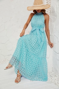 Detail of light blue halter maxi dress with textured checkered fabric and bow belt