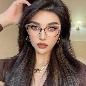 Fashionable black cat-eye glasses frame with gold metal temples worn by a female model