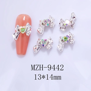 Detail of silver alloy bow nail art charm with AB heart rhinestone size 13x14mm