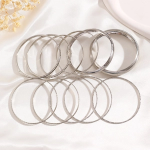Detail view of 12pcs silver stackable bracelets with smooth finish and textured designs