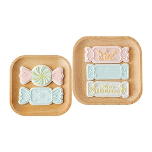 Christmas candy fondant molds and DIY baking tools on wooden plates for holiday cake decoration