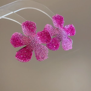 Macro detail of gradient pink crystal flower earrings with sparkling rhinestone petals