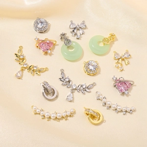 Detailed flat lay of gold and silver jewelry pendants with pearls and zircon stones