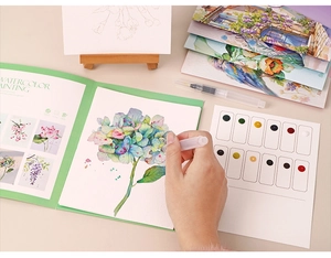 Detail of floral watercolor painting kit showing 12-color palette and water brush pen