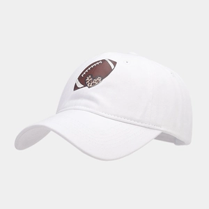 Macro shot of white cotton baseball cap showing detailed leopard heart embroidery