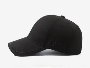 Detailed side view of black cotton baseball cap with tonal embroidery and fine stitching
