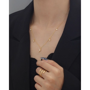 Elegant gold S925 sterling silver star necklace with zircon pavé on a female model