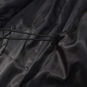 Detail of adjustable drawstring with plastic cord lock on black casual windbreaker coat