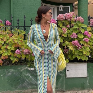 Close-up of deep V-neck and colorful crochet knit texture on a bohemian maxi dress