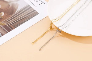 Detail of gold and silver heart necklaces with lobster clasp and adjustable chain