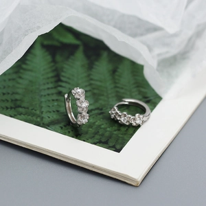 Detail shot of s925 sterling silver floral hoop earrings with sparkling zircon accents