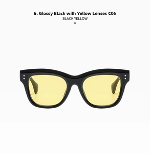 Close-up of retro square black frame sunglasses with transparent yellow lenses and silver rivets
