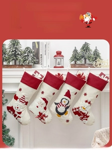 Set of four festive Christmas stockings with reindeer and snowman hanging on a fireplace