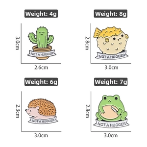 Detail view of four funny enamel frog pins with sizes and weights for various designs