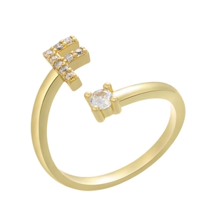 Macro shot of gold adjustable ring featuring micro-paved letter F and single solitaire stone