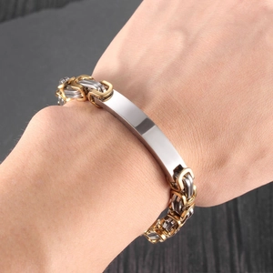 Close-up of titanium steel Byzantine chain bracelet with blank metal plate for custom engraving