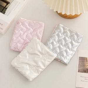 Collection of cute quilted heart and bow passport holders for stylish travel organization