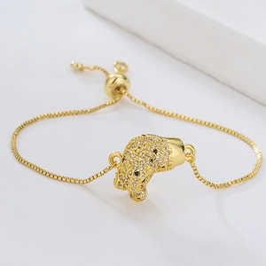 Macro detail of gold-plated leopard head bracelet with clear zircons and slider clasp