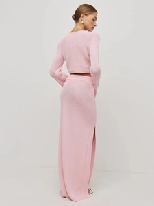 Detailed texture of pink knit long-sleeve crop top and side slit maxi skirt set