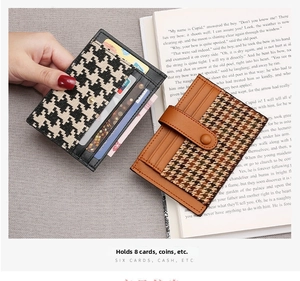 Detail view of slim houndstooth card holders with snap button closure for eight cards
