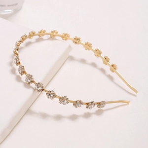 Elegant gold metal headband featuring sparkling rhinestone sunflower designs on white background